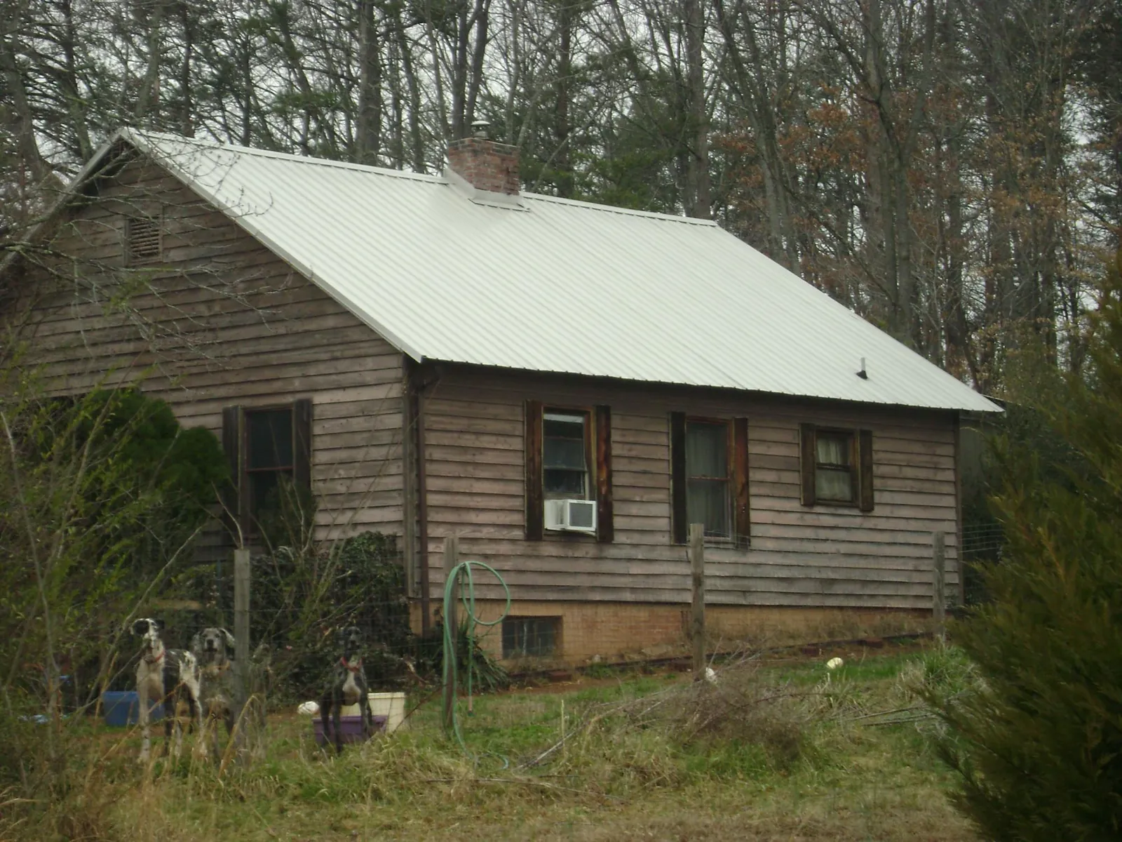 White metal roof on an old wood sided farmhouse, from a Metal Roof Installation job in Cazenovia